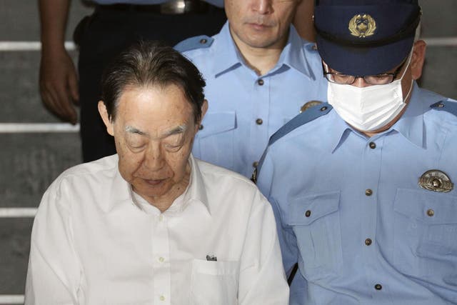 Hideaki Kumazawa leaving police station after he reportedly told investigators he feared his late son might harm others