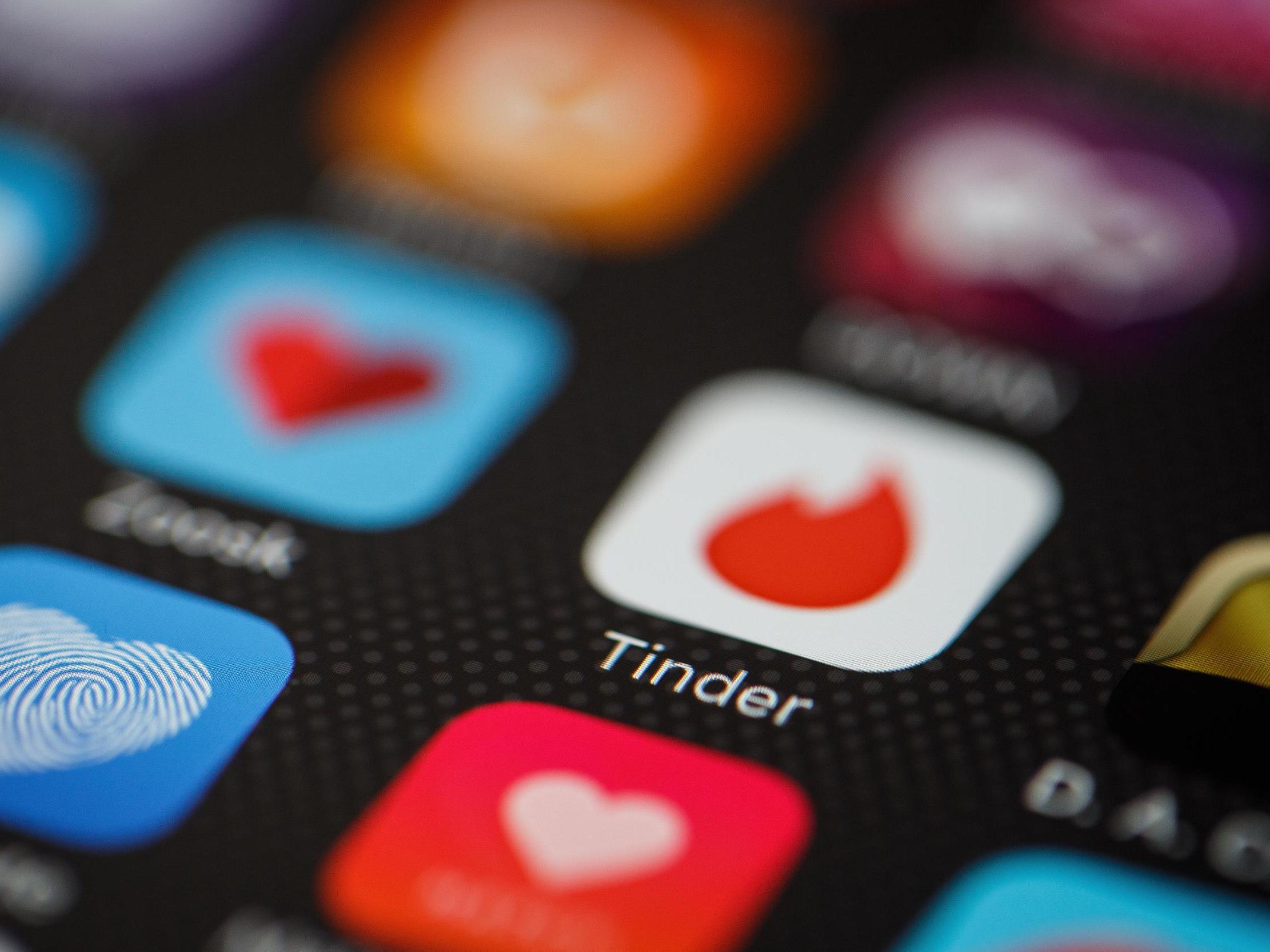 The "Tinder" app logo is seen amongst other dating apps on a mobile phone screen on November 24, 2016 in London, England.