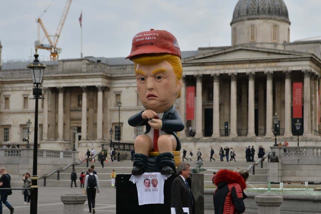 Protesters unveiled a 16ft talking robot of the US president sitting on a gold toilet in Trafalgar Square