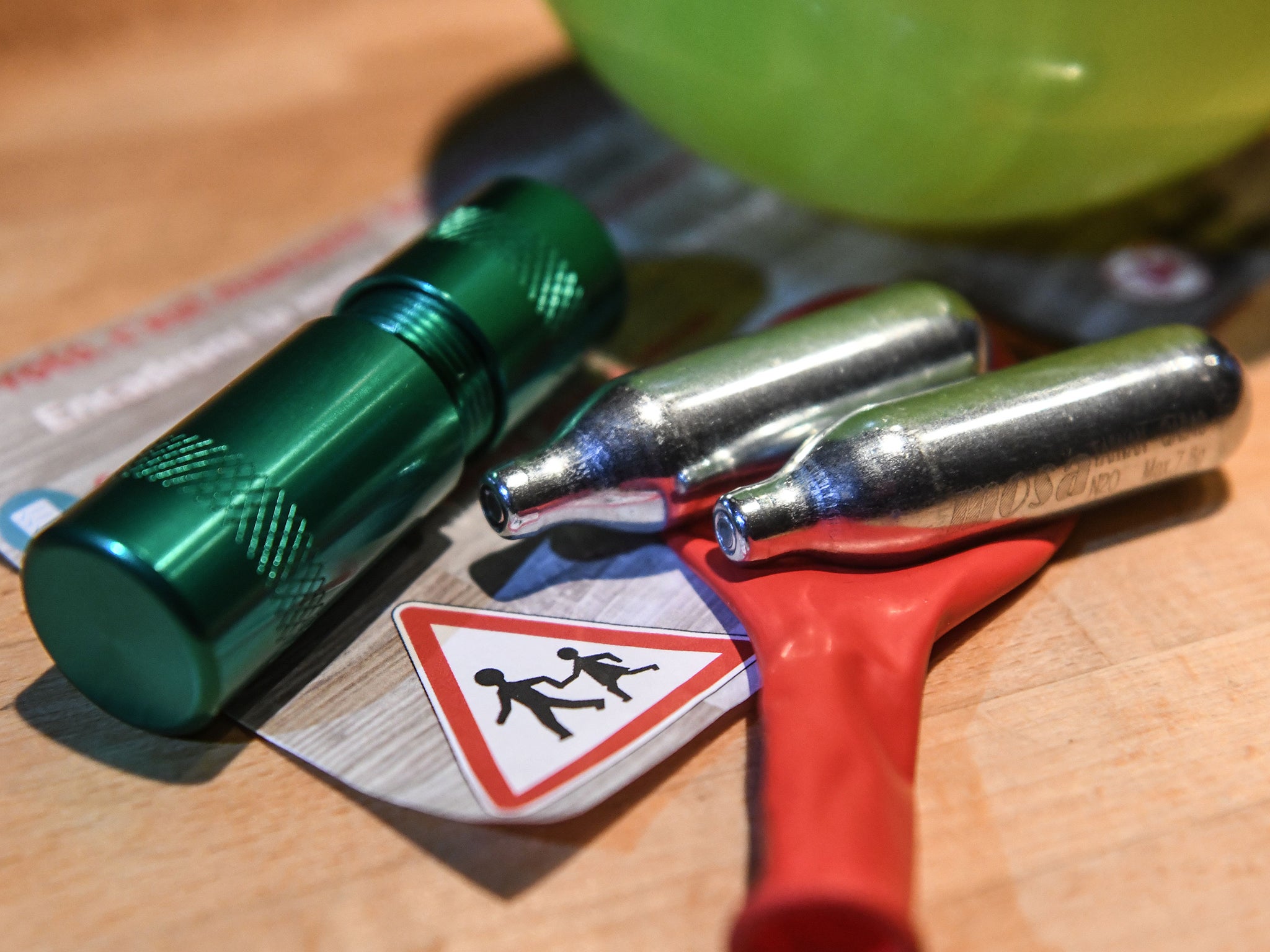 Balloons and canisters of nitrous oxide, commonly known as laughing gas, is now illegal