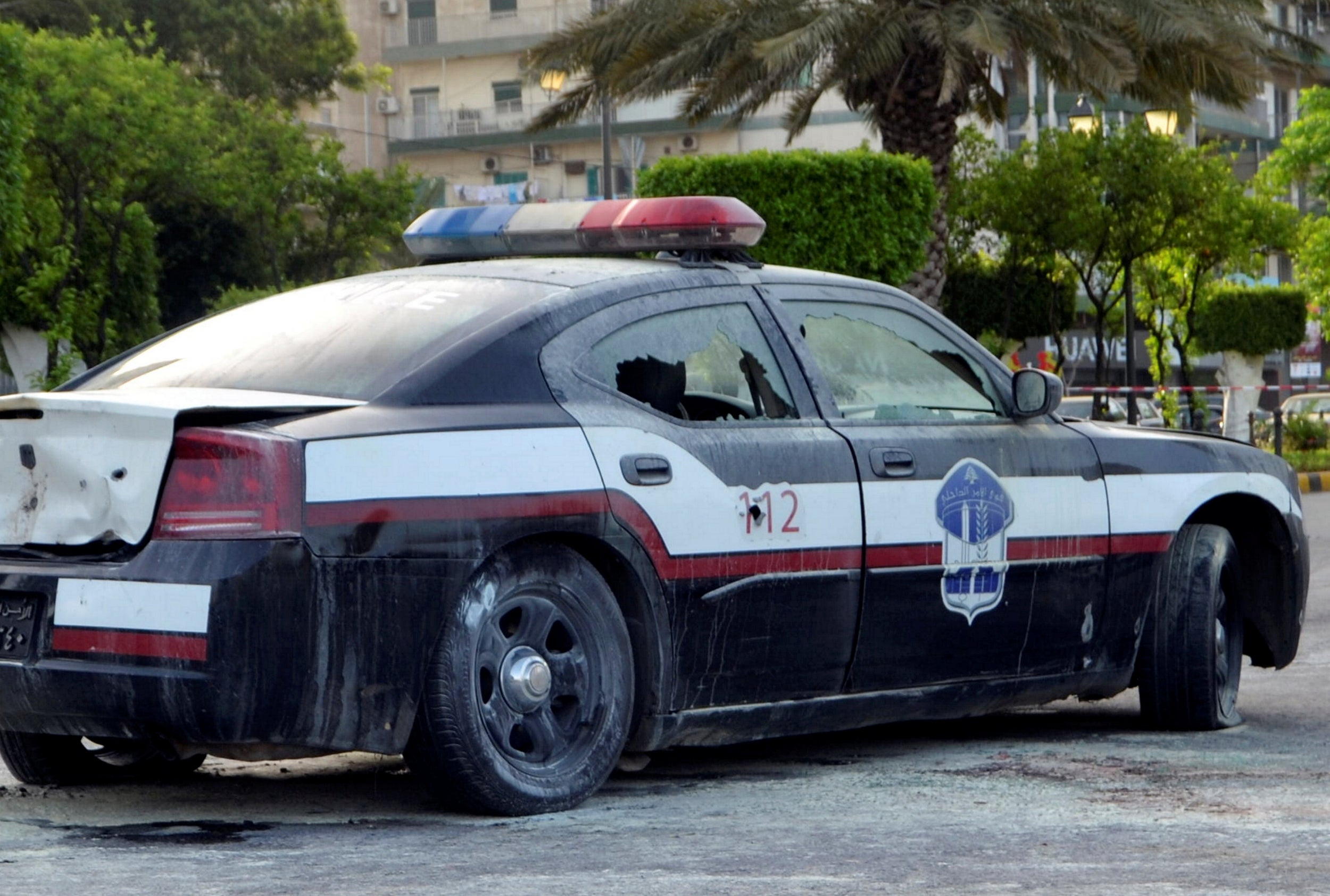 A damaged police car is seen at the scene where a militant attacked a security forces patrol on Monday, in Lebanon's northern city of Tripoli, Lebanon June 4, 2019