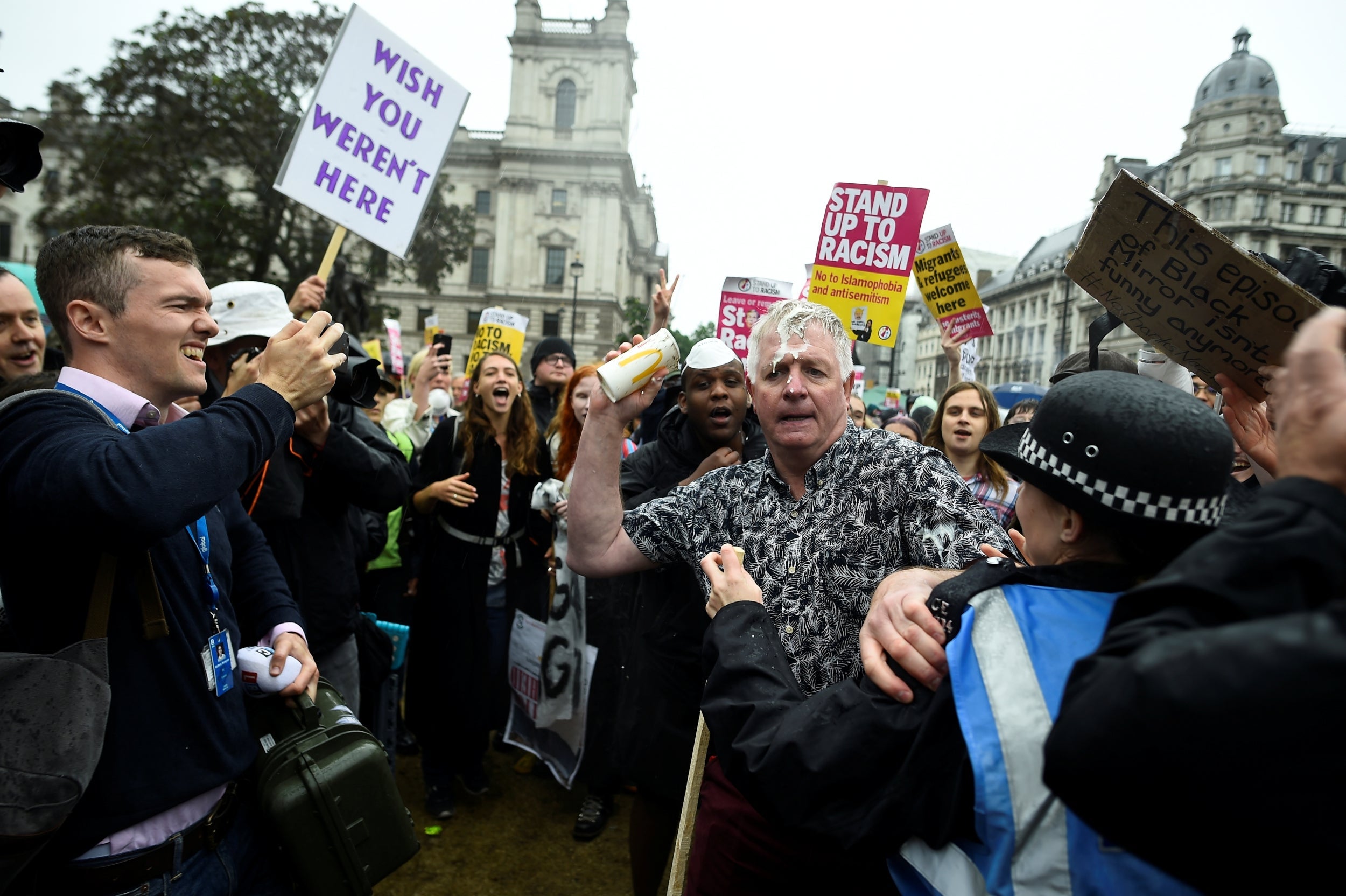 A pro-Trump demonstrator reacts after being hit by a milkshake at a rally in London