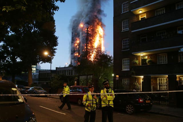 Police begin cordoning off areas of North Kensington as Grenfell Tower is engulfed by flames in the early hours on the morning