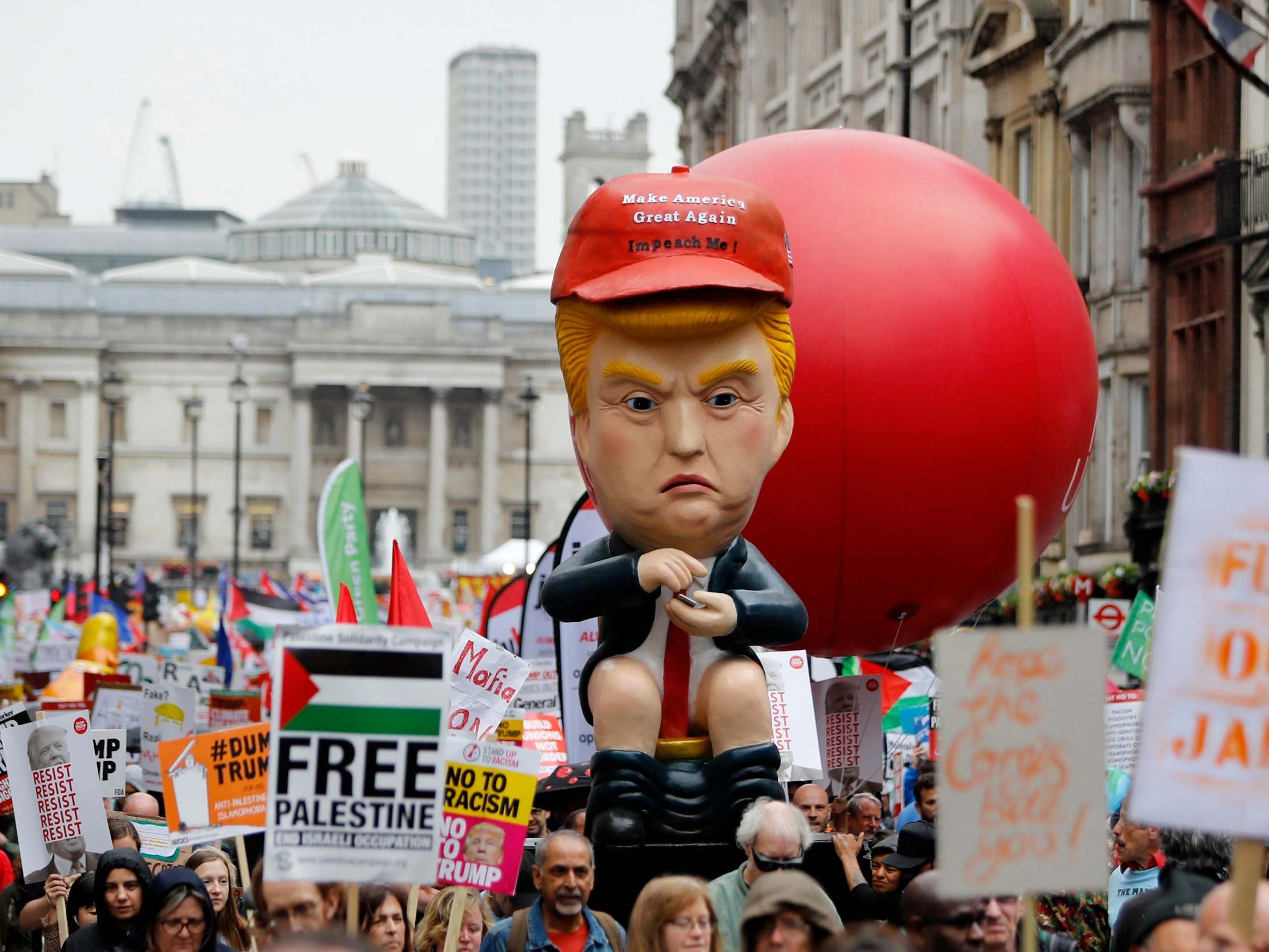 An effigy of Donald Trump is carried by protestors demonstrating against the visit of the US President Donald Trump along Whitehall in London in 2019