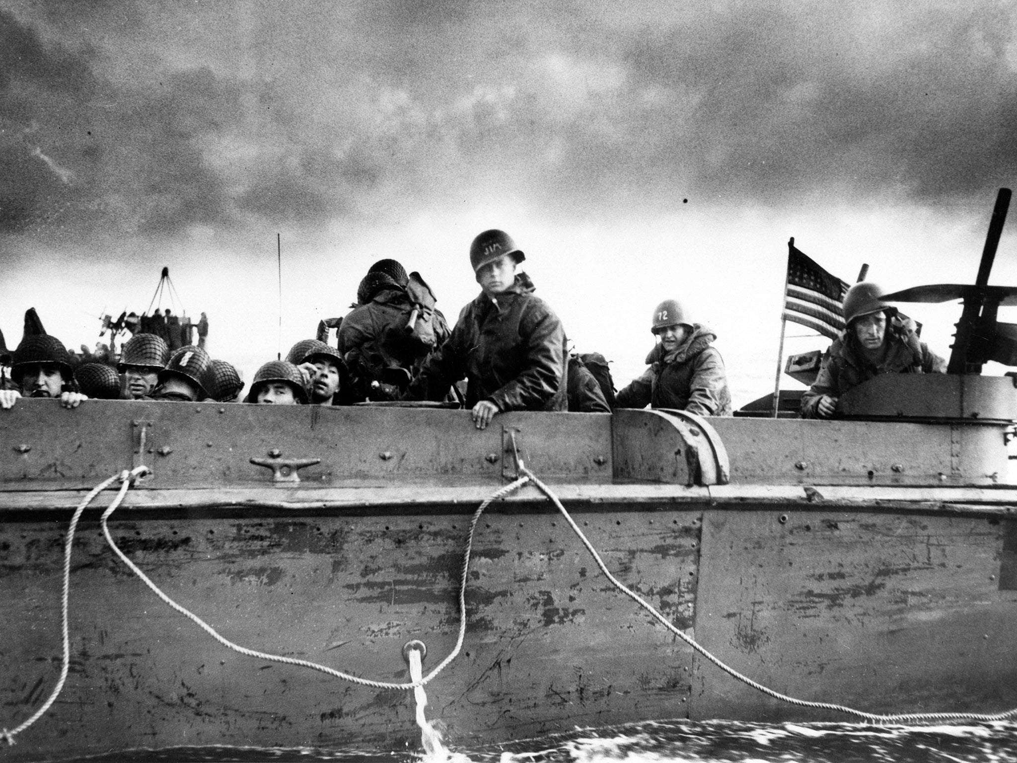 US army troops aboard a Coast Guard landing vehicle approach a beach on D-Day in Normandy, France, on June 6, 1944