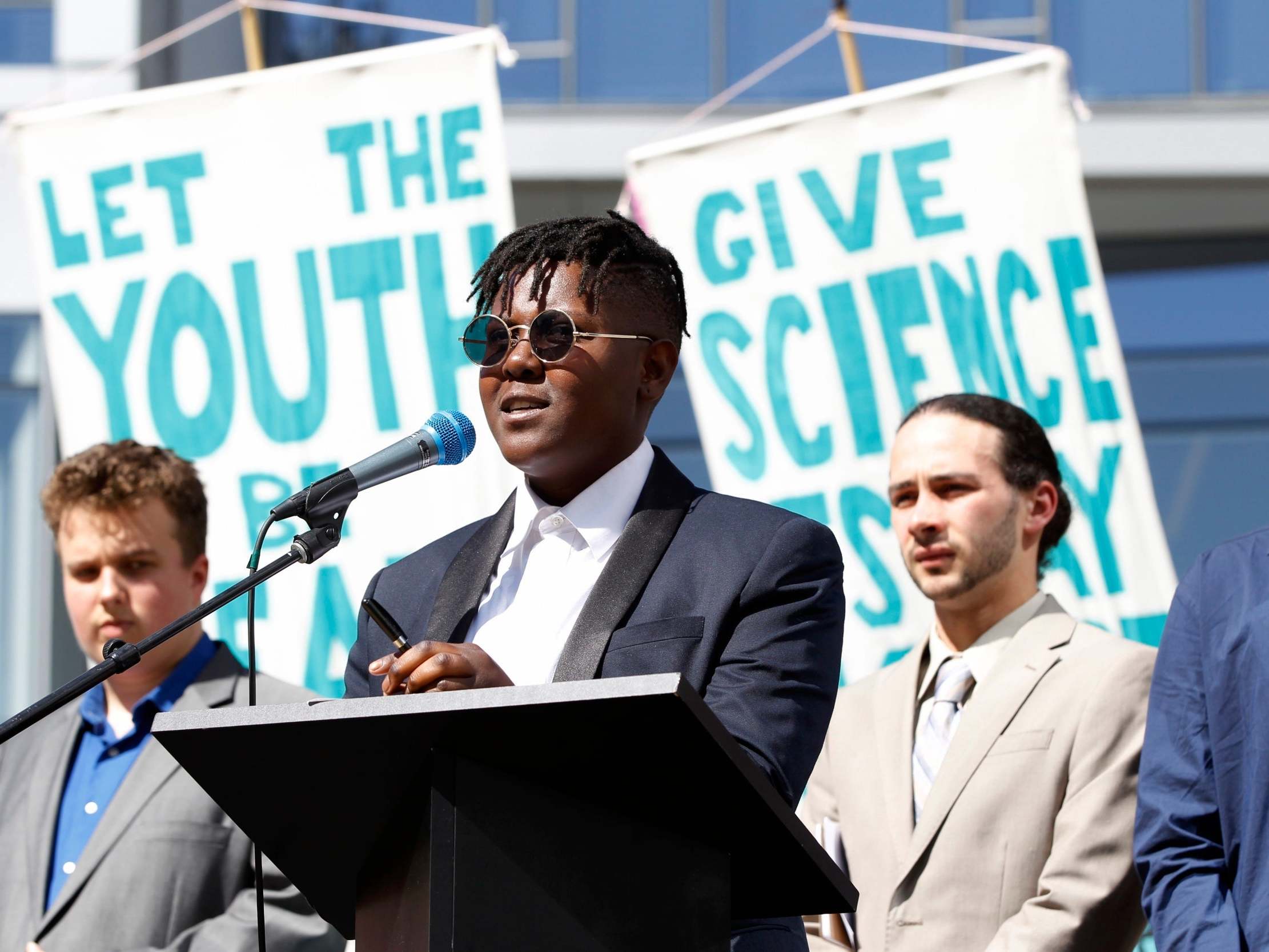 Vic Barrett, of White Plains, NY, speaks at a rally for a group of young people who filed a lawsuit against the US government