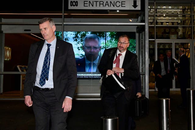Australian Federal Police investigators leave the ABC building in Sydney