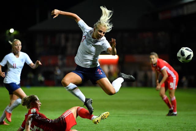 Alex Greenwood of England is tackled by Rhiannon Roberts of Wales during the Women's World Cup qualifier between Wales Women and England Women at Rodney Parade on 31 August 2018