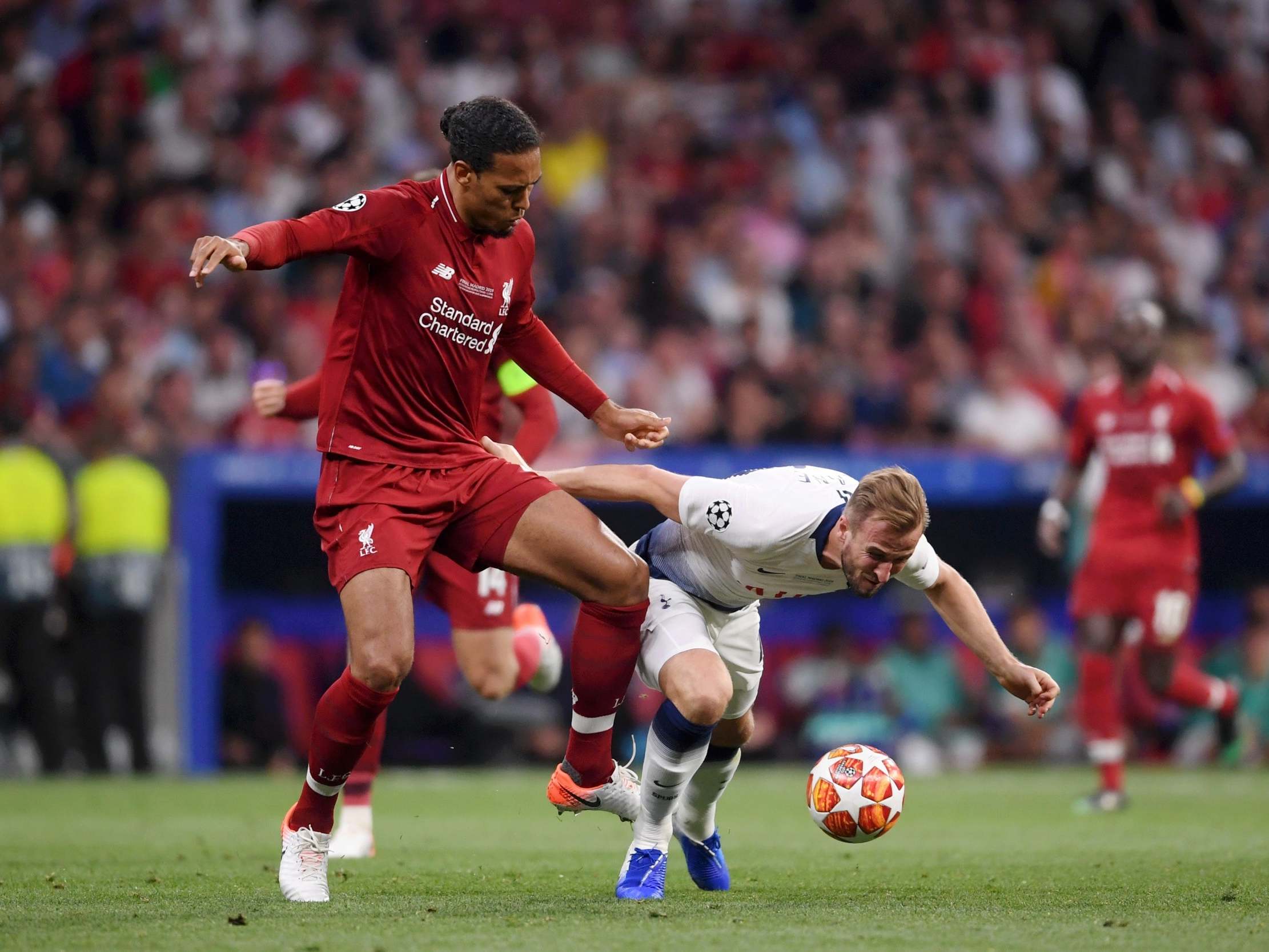 Van Dijk jostles Harry Kane for the ball in the Champions League final
