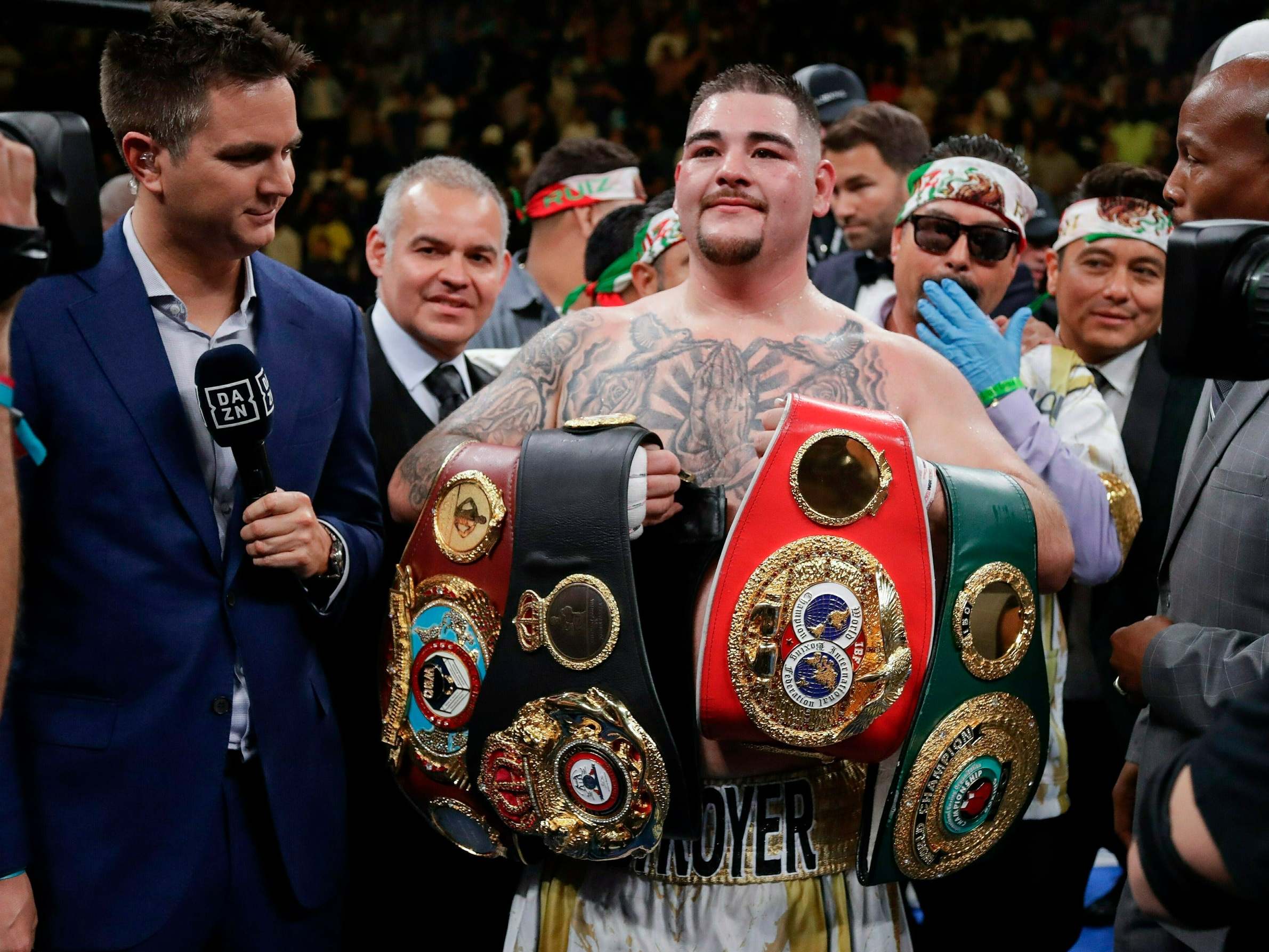 Andy Ruiz celebrates with the heavyweight belts