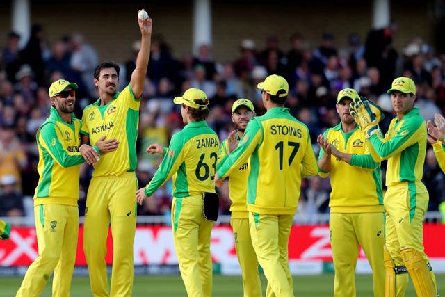 Australia's Mitchell Starc holds up the ball to celebrate