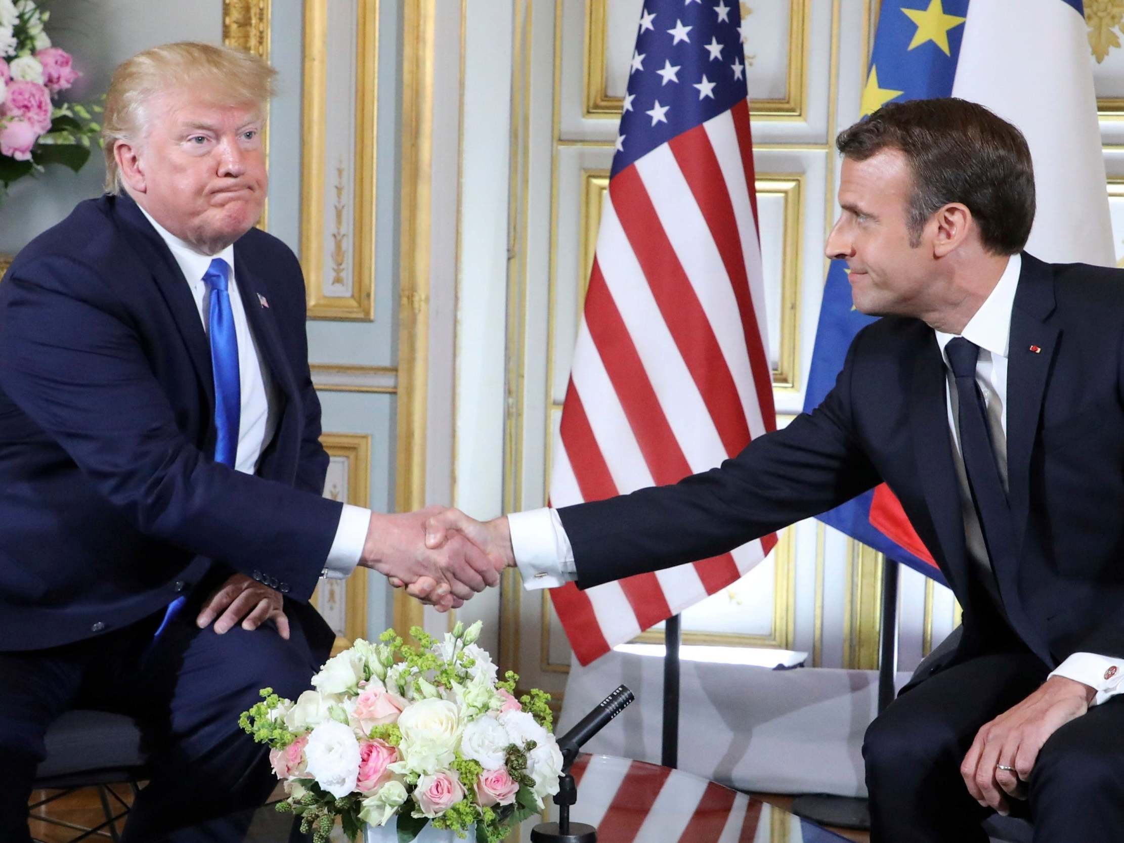 Donald Trump shakes hands with Emmanuel Macron in Caen
