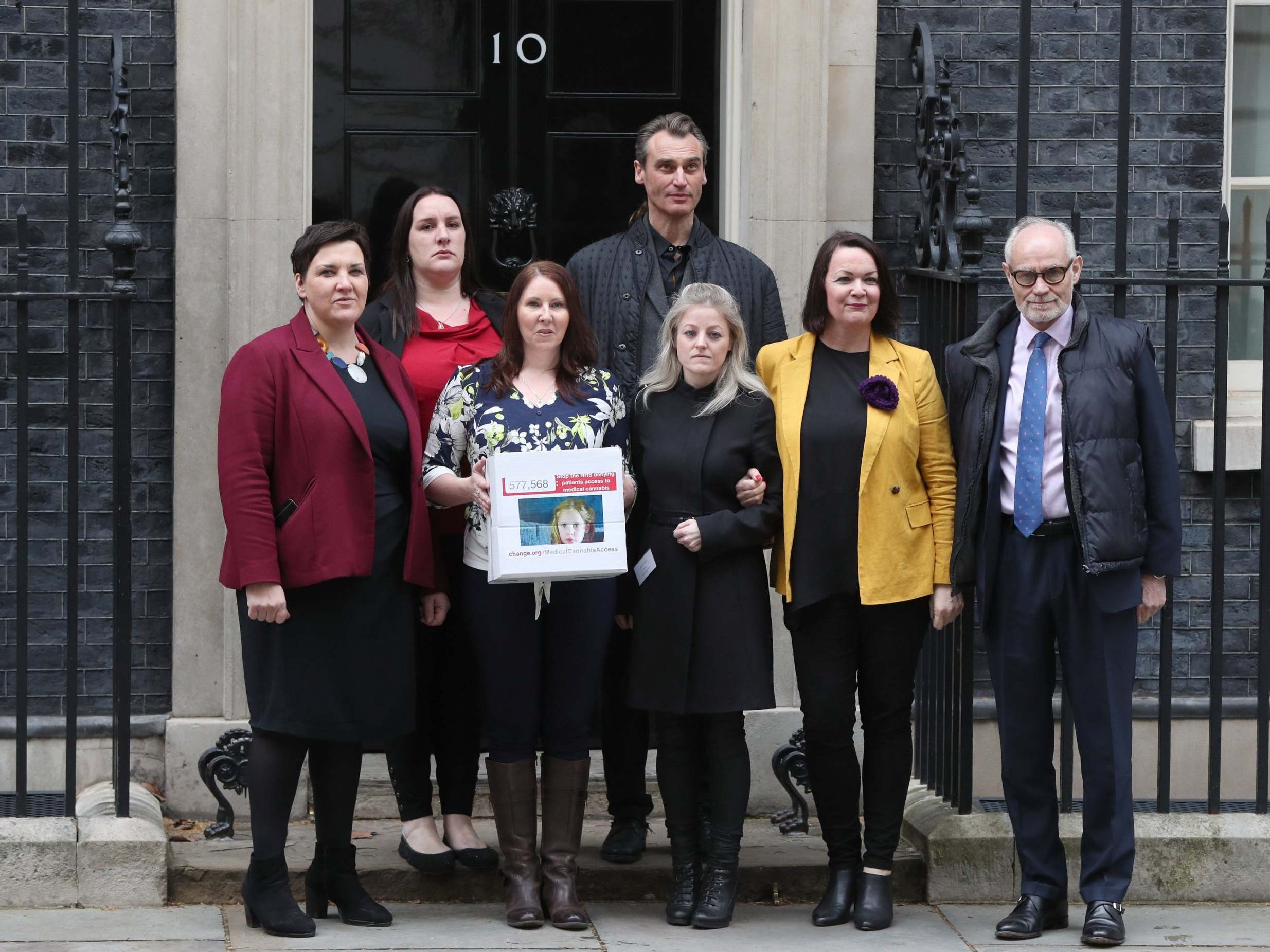 Campaigners (left to right) Toni Antoniazzi, Emma Appleby, Joanne Griffiths, Benedict Lamb, Ashley West, Julie Young and Crispin Blunt, hand a petition demanding rule changes on medical cannabis use