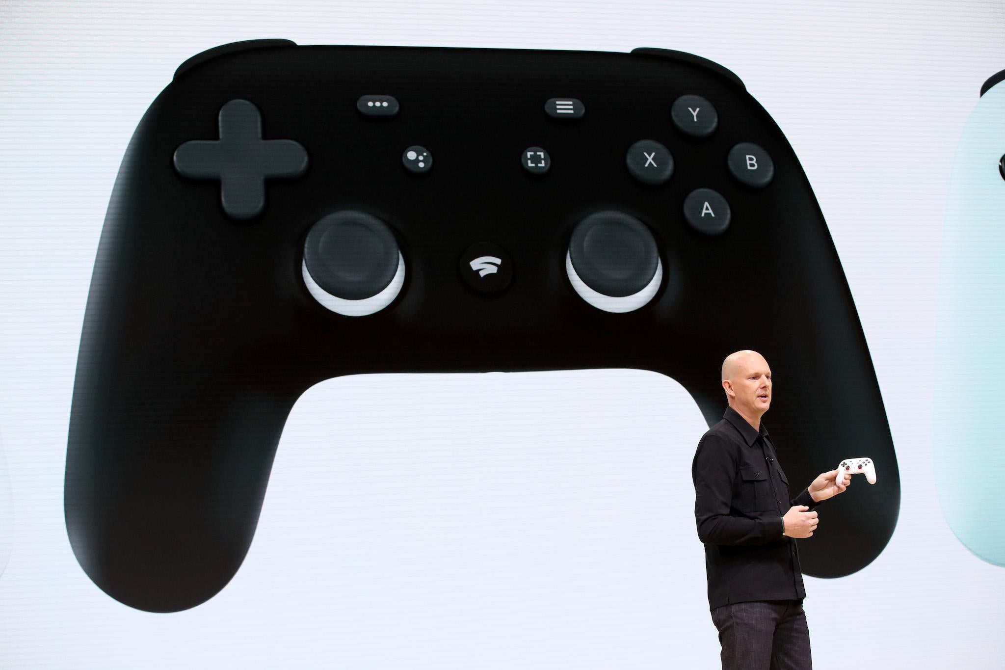 <p>Google vice president and general manager Phil Harrison shows the new Stadia controller as he speaks during the GDC Game Developers Conference on March 19, 2019</p>
