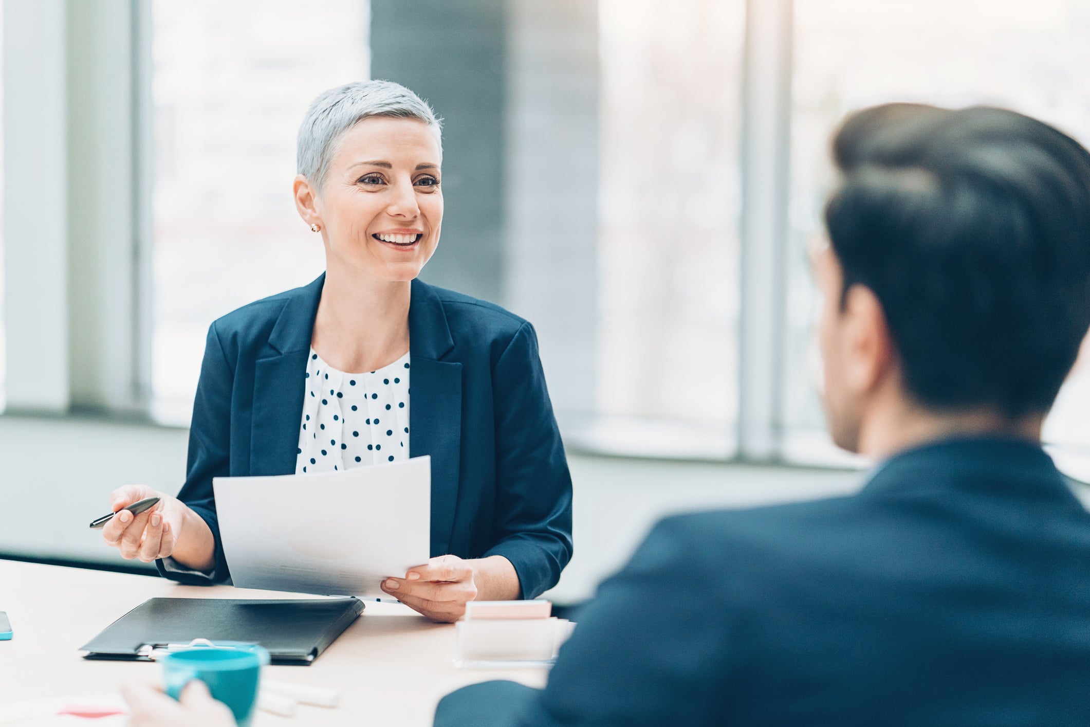 Two businesspersons talking in the office