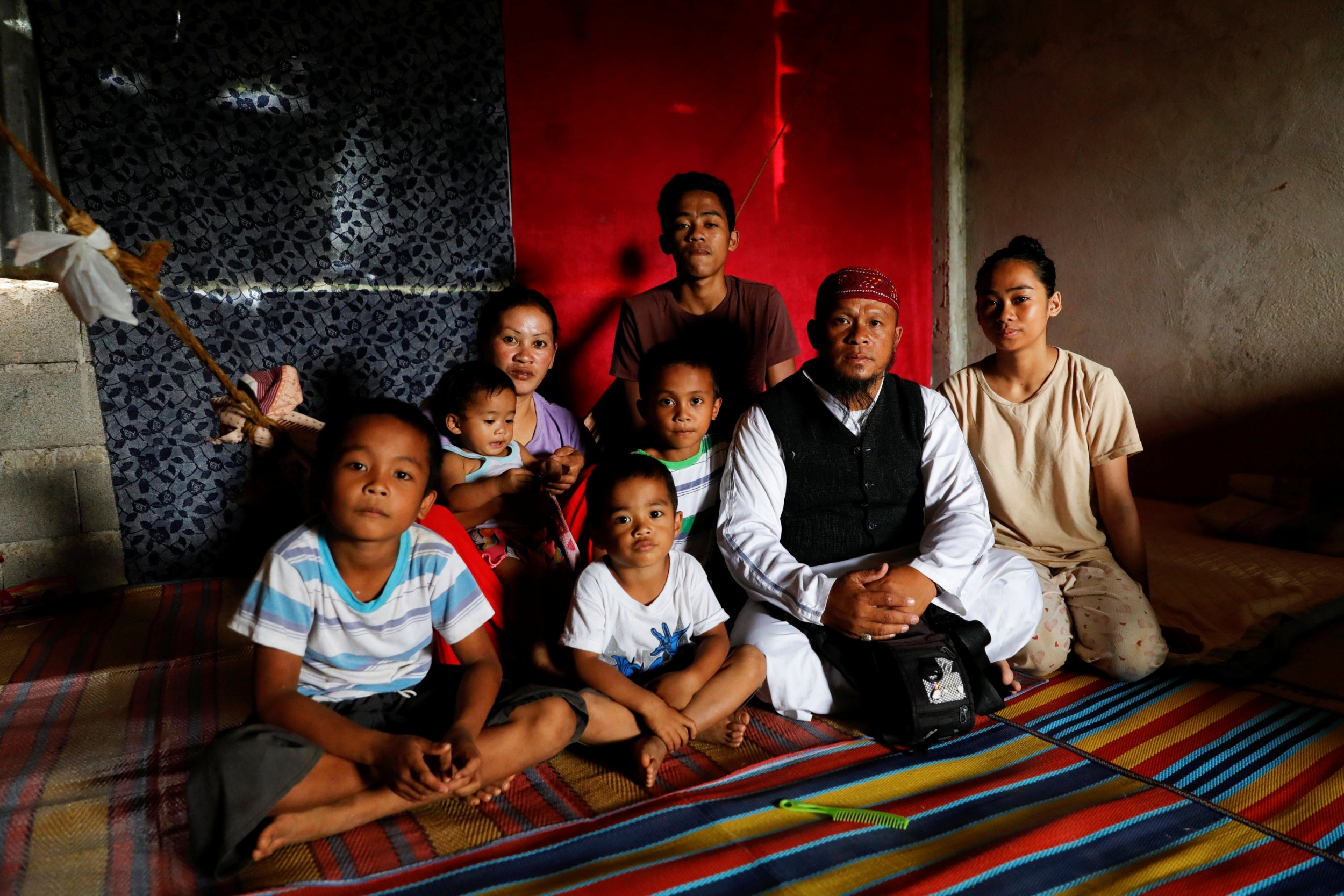 Mohammad sits with his family in a school-turned-evacuation centre