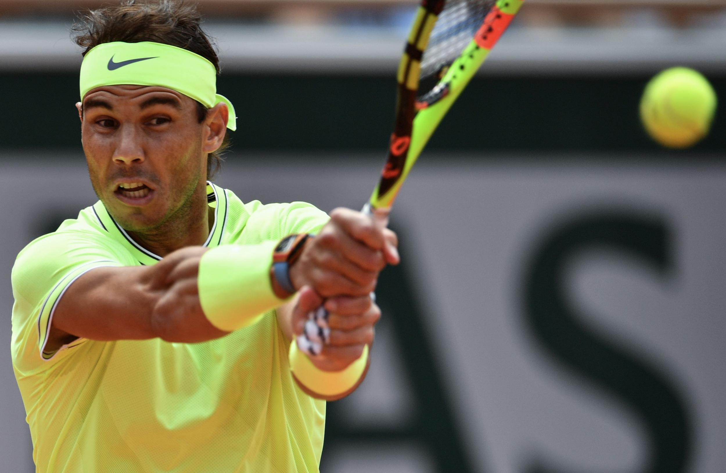 Rafael Nadal plays a backhand shot during the second set