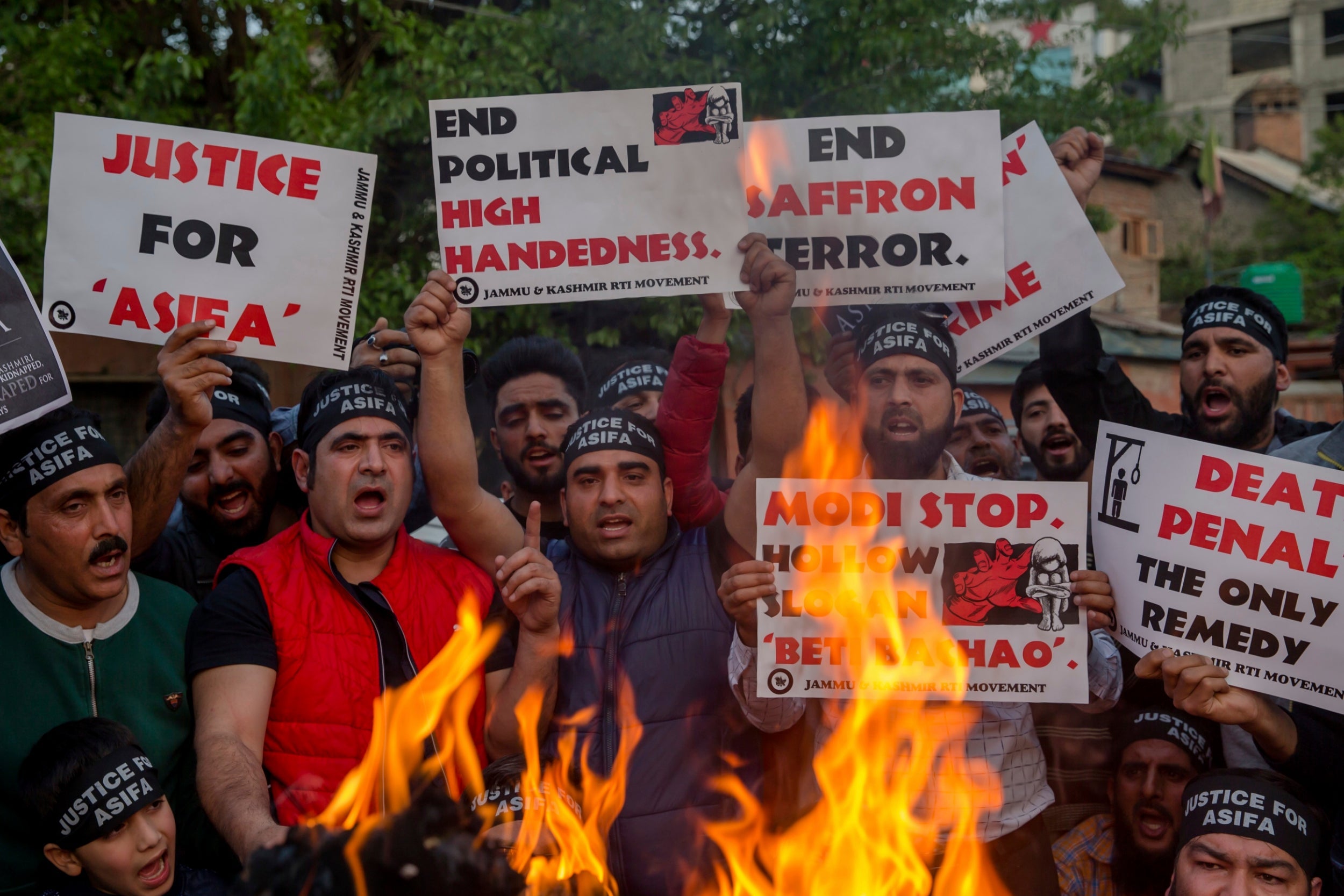 Kashmiri activists hold torches and march in a protest against the rape and murder of an 8-year-old girl, in Srinagar, Indian controlled Kashmir