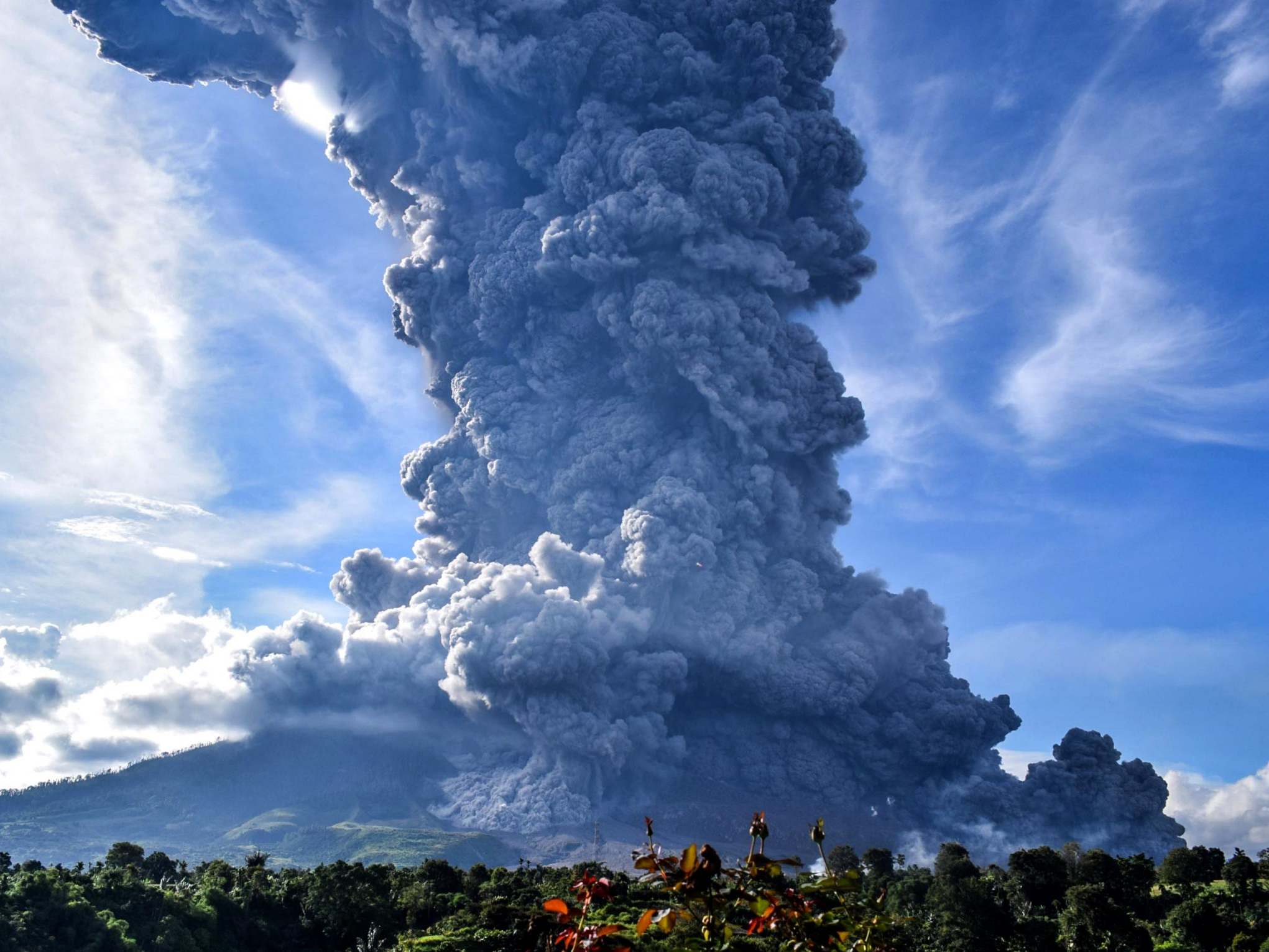 Mount SInabung spews volcanic ash above a village in North Sumatra