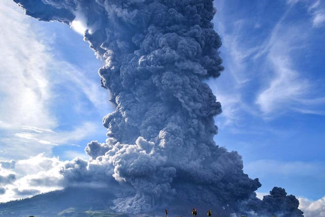 Mount SInabung spews volcanic ash above a village in North Sumatra
