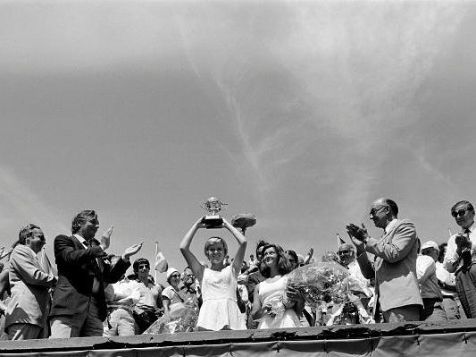 Sue Barker lifts aloft the trophy after winning the French Open
