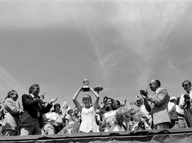 Sue Barker lifts aloft the trophy after winning the French Open