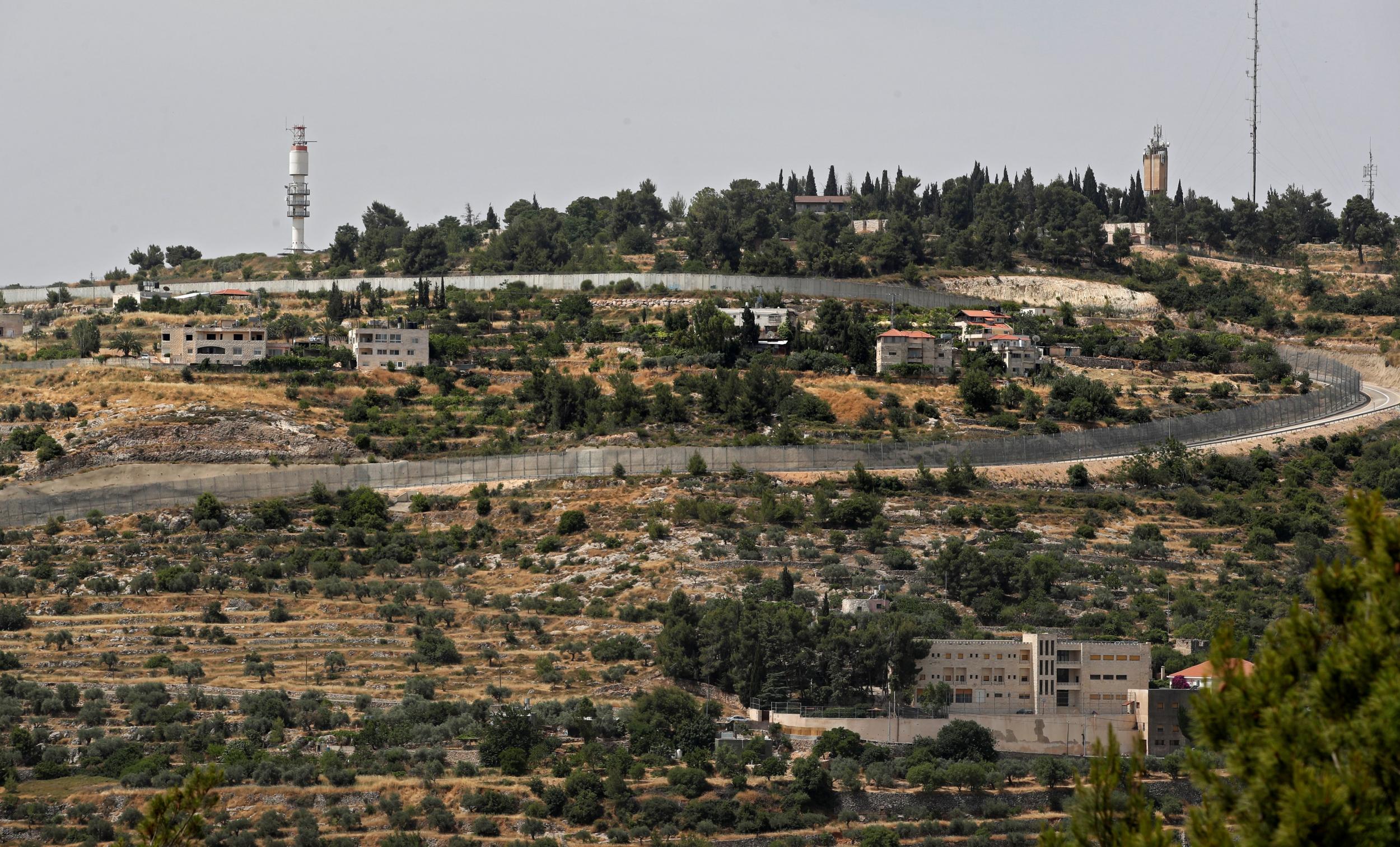 This picture taken on June 6, 2019 shows Israel's controversial separation barrier separating the West Bank city of Beit Jala near Bethlehem and Jerusalem