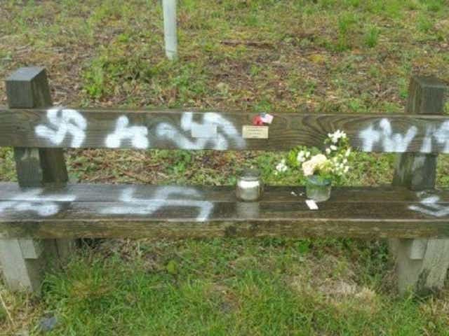 Commemorative bench spray painted with a swastika in Twyford Woods