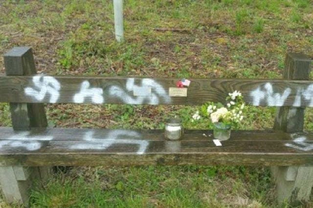 Commemorative bench spray painted with a swastika in Twyford Woods