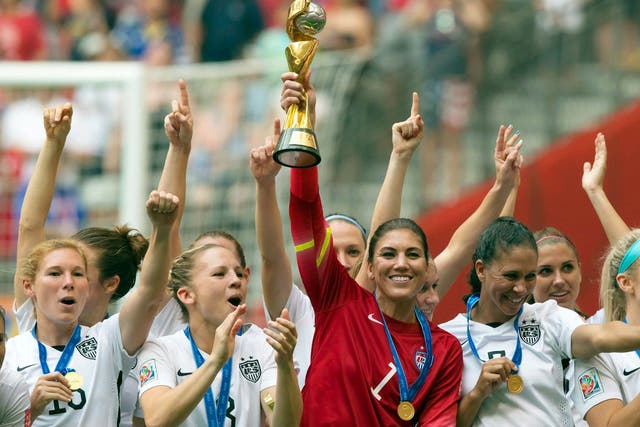 <p>In this July 5, 2015, file photo, United States goalkeeper Hope Solo hoists the trophy as she and her teammates celebrate defeating Japan to win the FIFA Women's World Cup soccer championship in Vancouver, British Columbia, Canada</p>