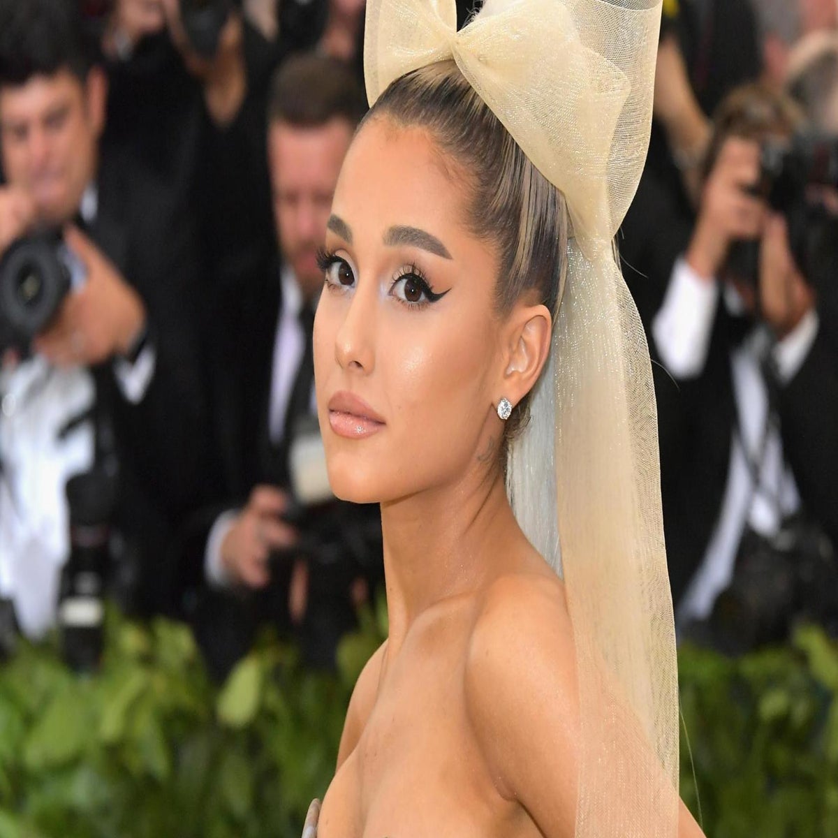 Ariana Grande cuts a stylish figure as she touches down in Japan