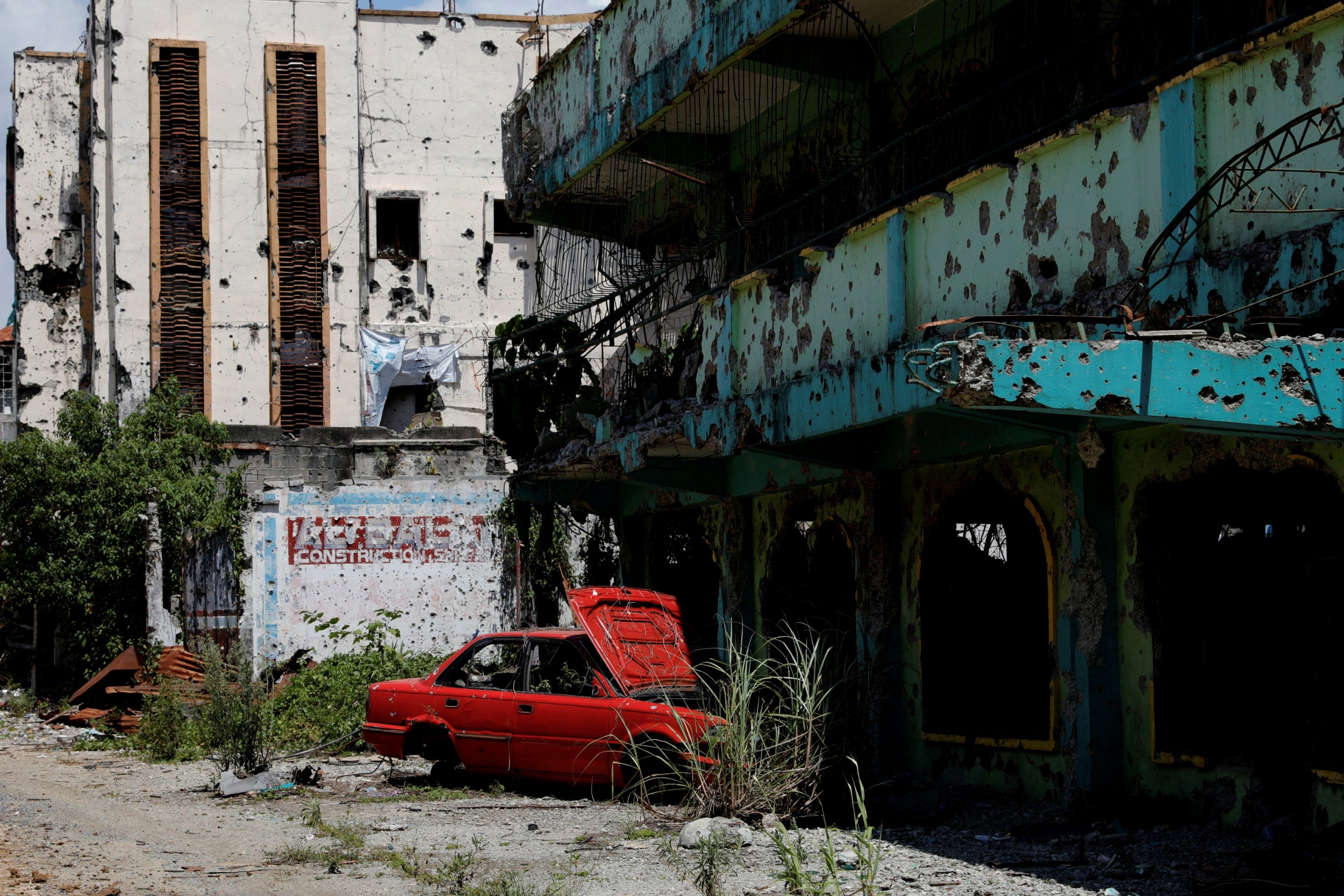 A dilapidated car and building at the centre of the war-torn area of Marawi City in the Philippines. The city remains abandoned two years since pro-Islamic State militants began their attacks