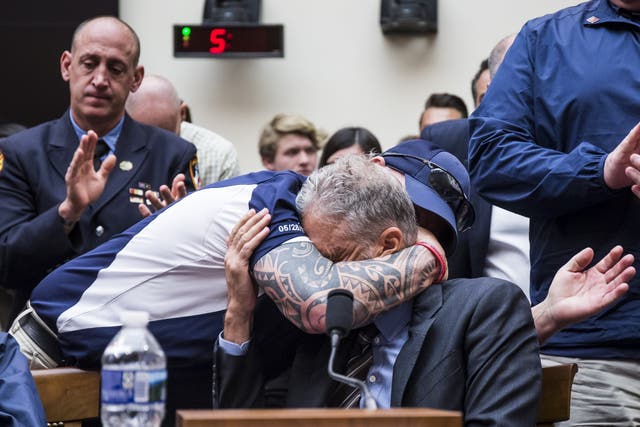 Jon Stewart is hugged by FealGood Foundation co-founder John Feal after his speech on the treatment of 9/11 first responders