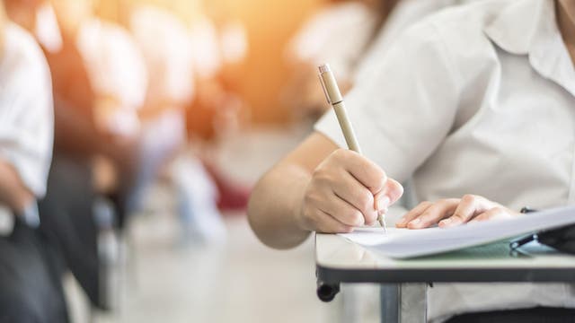 Exam with school student having a educational test