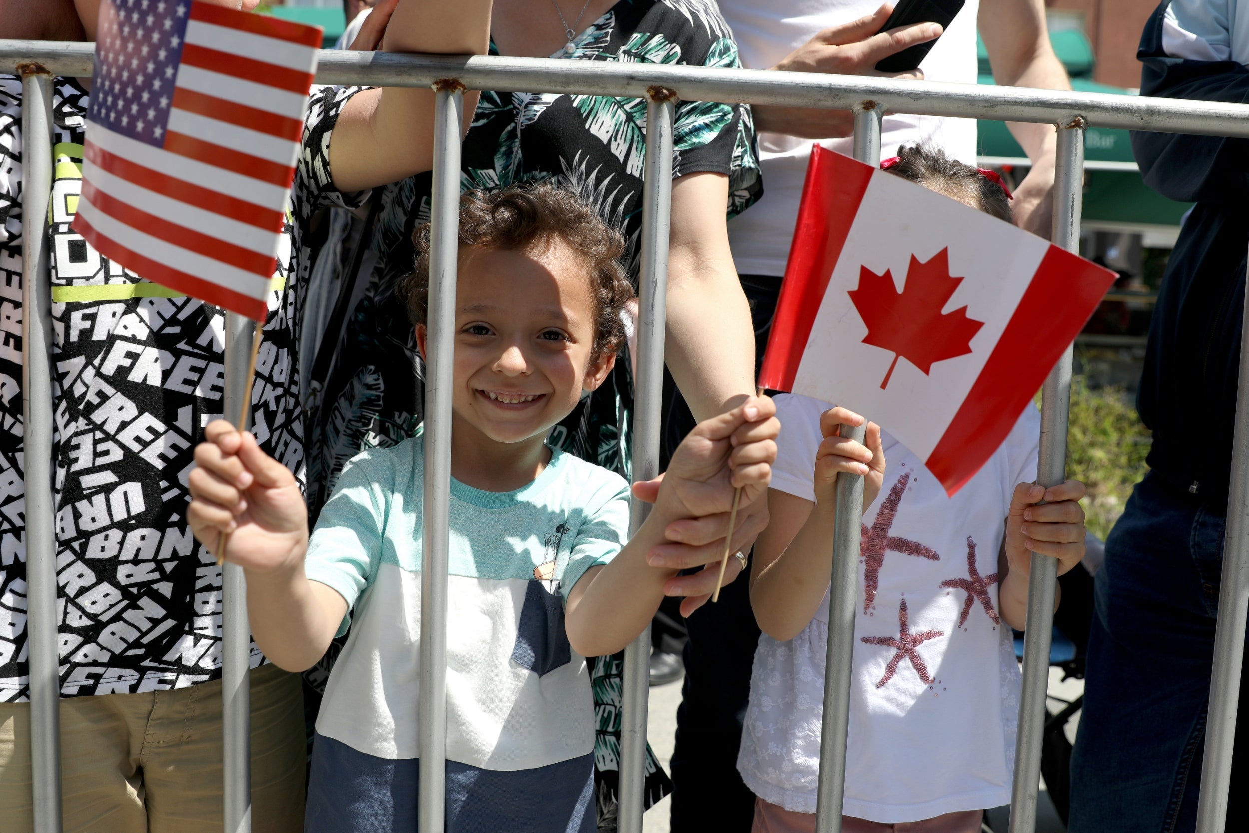 A child holds US and Canadian flags at the 20th anniversary of the deployment of Nato troops in Kosovo (Reuters)