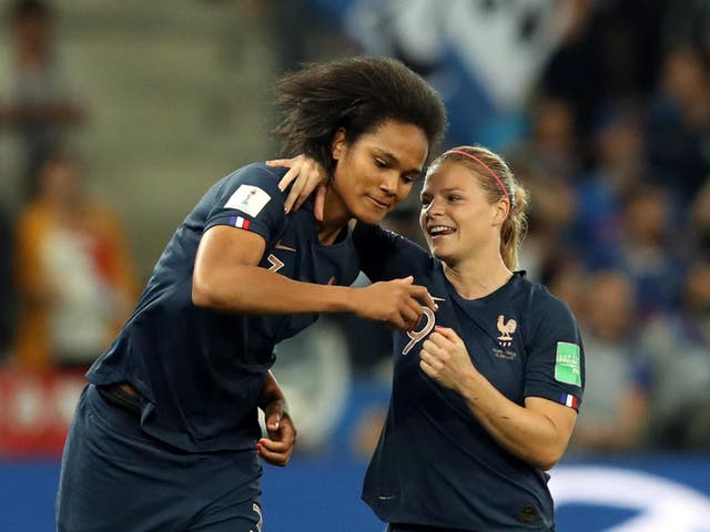Wendie Renard celebrates France's second goal with Eugenie Le Sommer