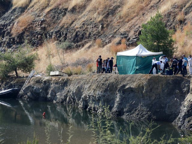 Cypriot police remove the remains of a girl, believed to be a six-year-old, from a lake near the village of Xiliatos