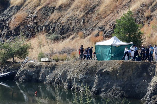 Cypriot police remove the remains of a girl, believed to be a six-year-old, from a lake near the village of Xiliatos