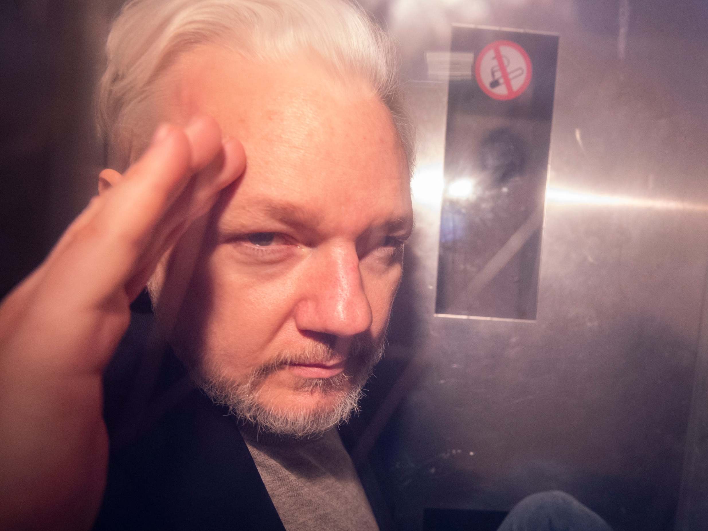Julian Assange in a prison van leaving Southwark Crown Court in May