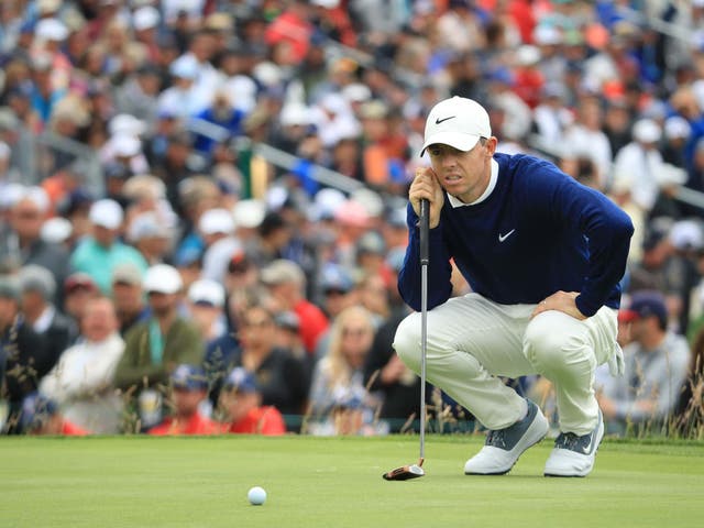 Rory McIlroy eyes up a putt on the third green at Pebble Beach