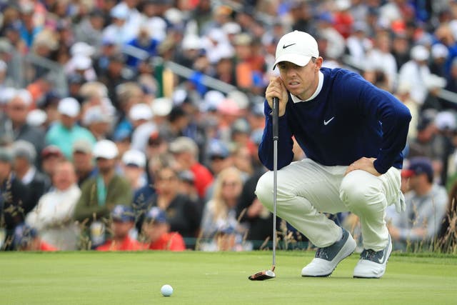 Rory McIlroy eyes up a putt on the third green at Pebble Beach