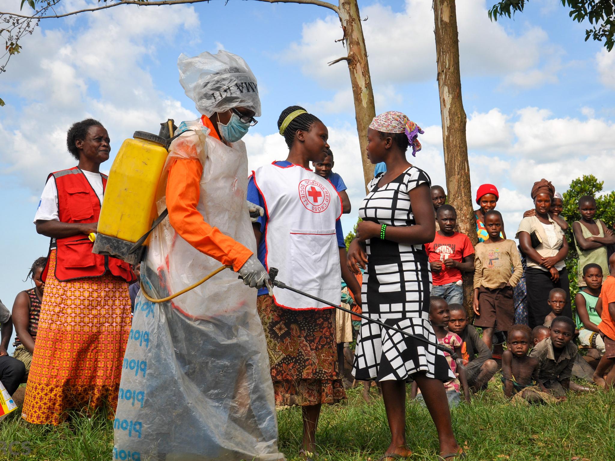 A scene from a play portraying the safe and dignified burial process. Uganda Red Cross uses theatre in communities to disseminate critical information about Ebola