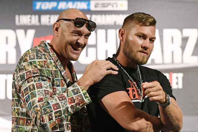 Tyson Fury and Tom Schwarz pose during their press conference