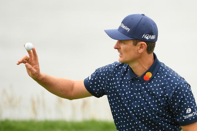 Justin Rose acknowledges the crowds on the eighth green 