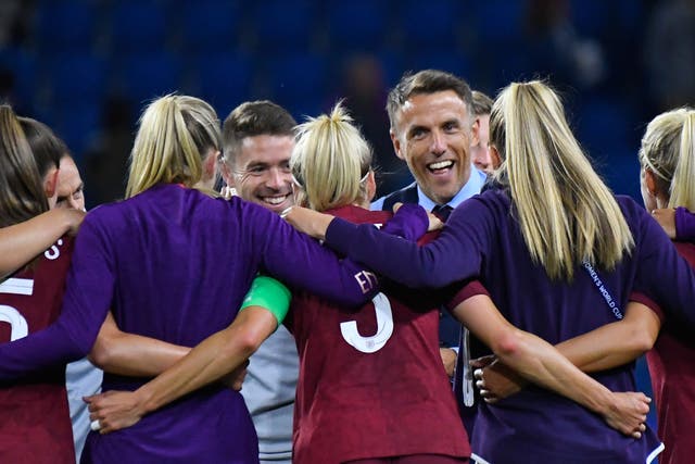 Phil Neville in a post-match huddle with his England players