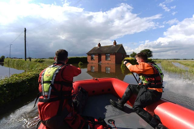 Rescue workers in Wainfleet after the River Steeping breached its banks
