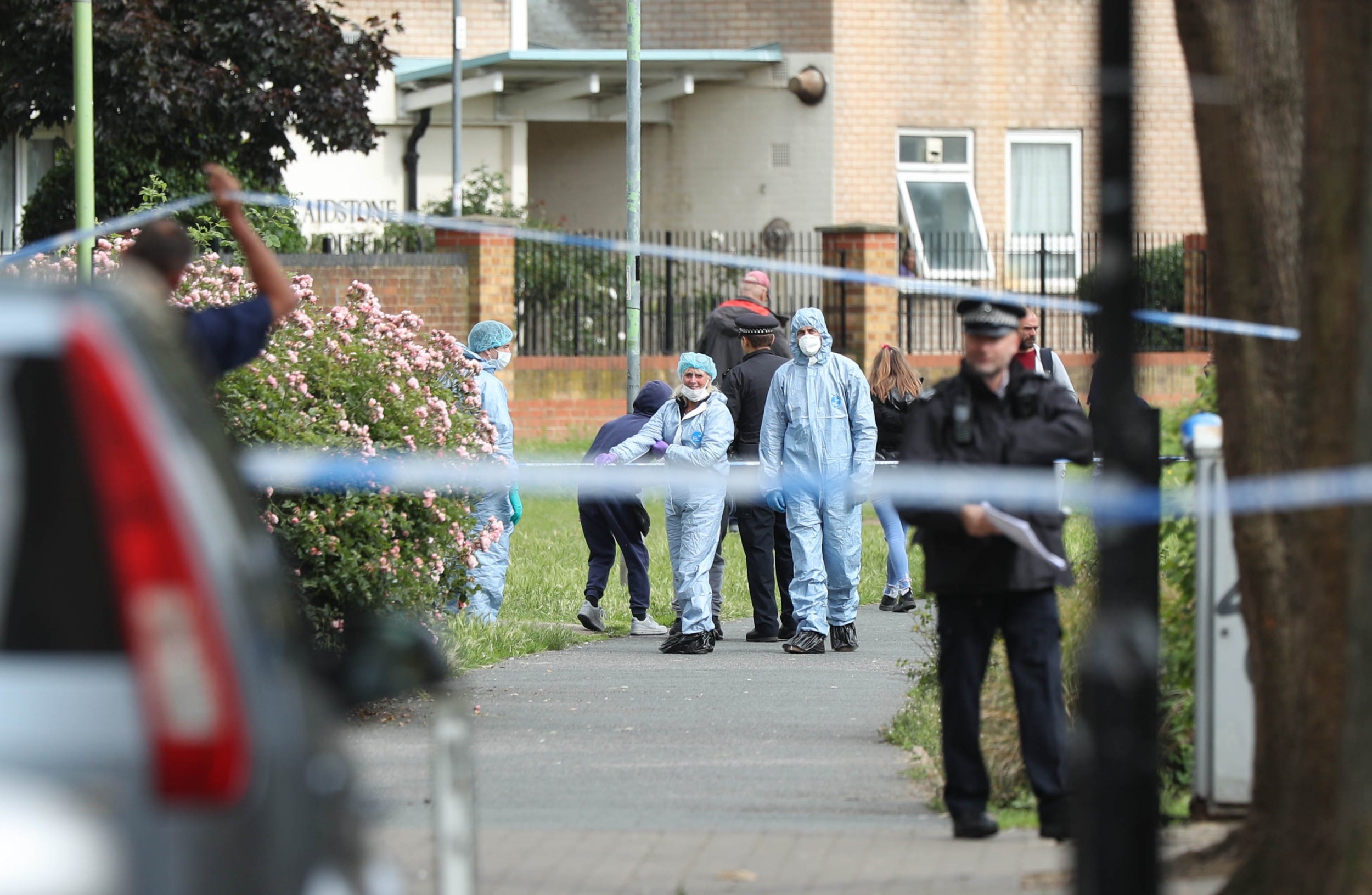 Police and forensics officers at the scene in Tower Hamlets, where man was stabbed to death on Sunday