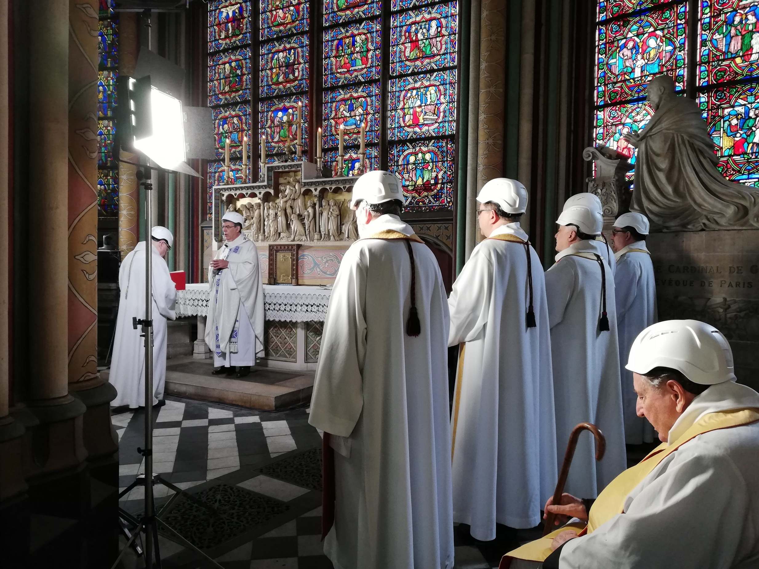 Clerics in hard hats attend a mass led by Michel Aupetit, Archbishop of Paris, in Notre Dame