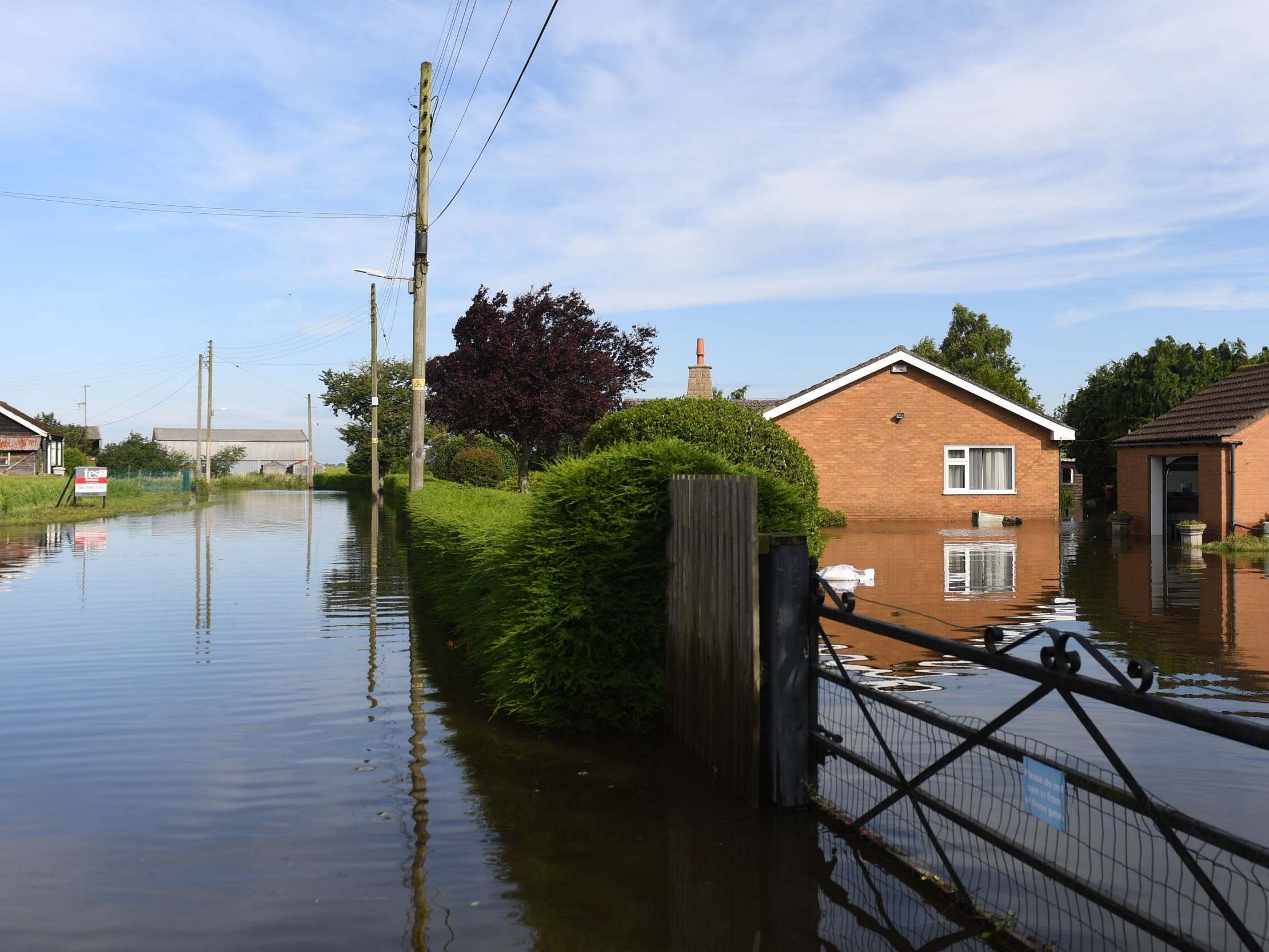 Flooded houses on Matt Pitts Lane in Wainfleet All Saints, Linconshire, after more than two months of rain fell in just two days