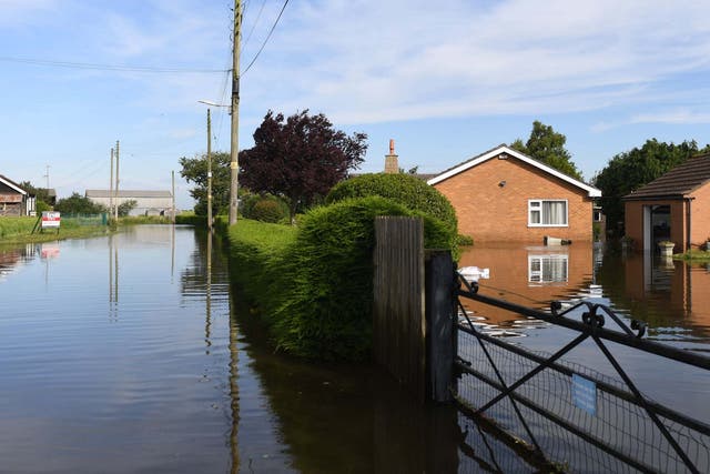 Flooded houses on Matt Pitts Lane in Wainfleet All Saints, Linconshire, after more than two months of rain fell in just two days